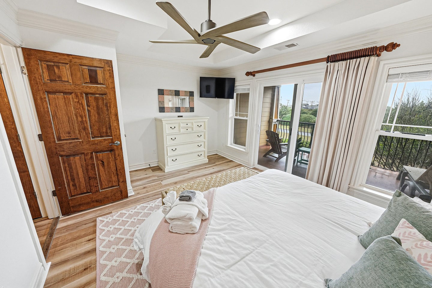 Enjoy bright mornings, cozy evenings, and easy balcony access from this relaxing coastal-inspired bedroom retreat.