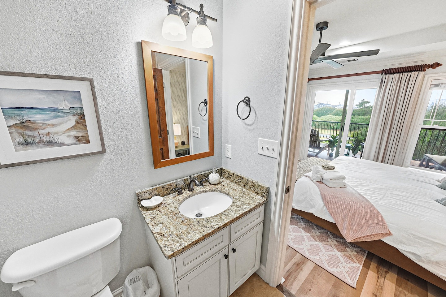 Private ensuite bathroom connected to Bedroom 2 featuring granite countertops and convenient in-room access.
