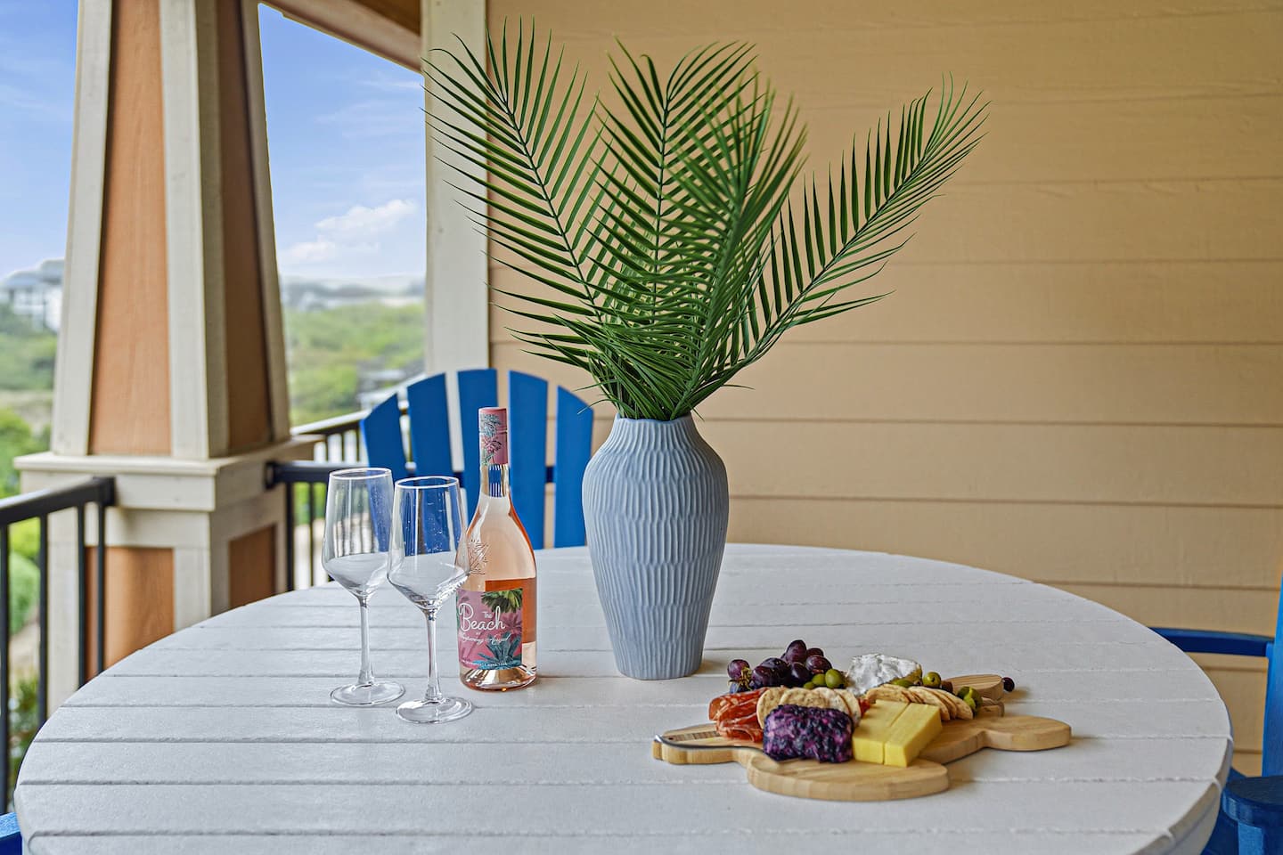 Spacious main balcony with seating for four, ideal for sunset drinks, seafood takeout, or planning your next beach day.