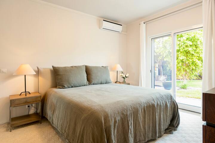 Master bedroom with king bed, en suite bathroom and access to the back garden
