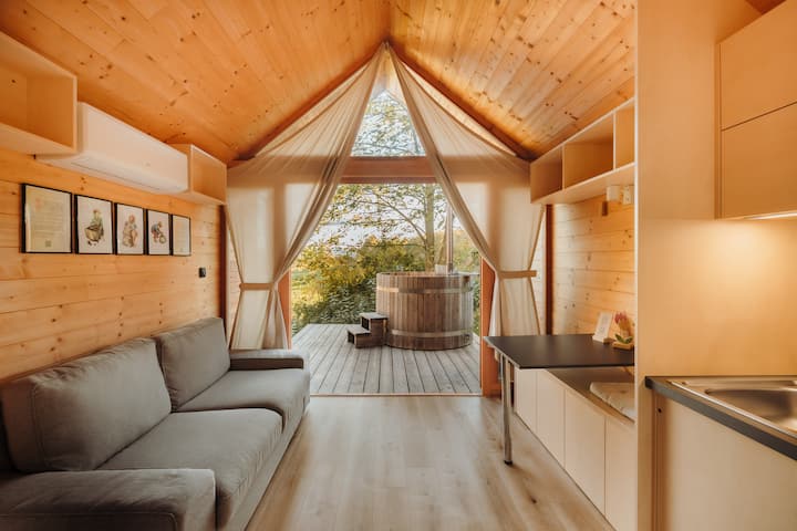 Living room with a view of nature and a hot tub