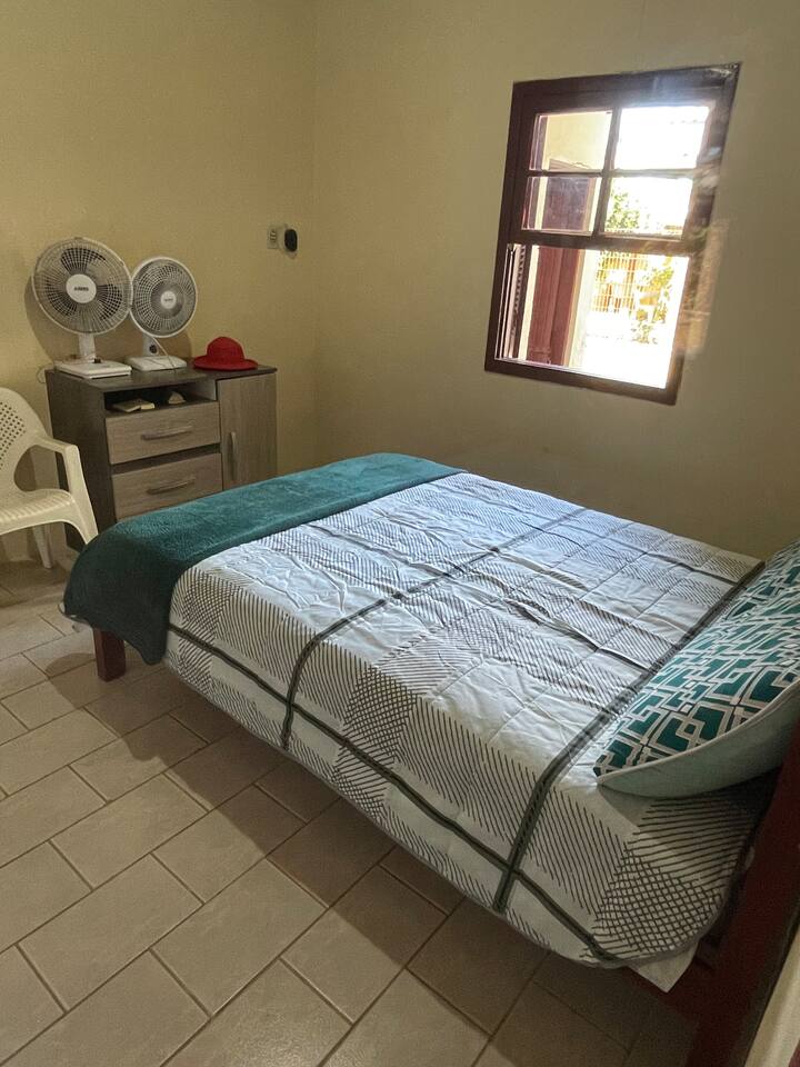 Room 2 with a double bed, dresser, and curtain