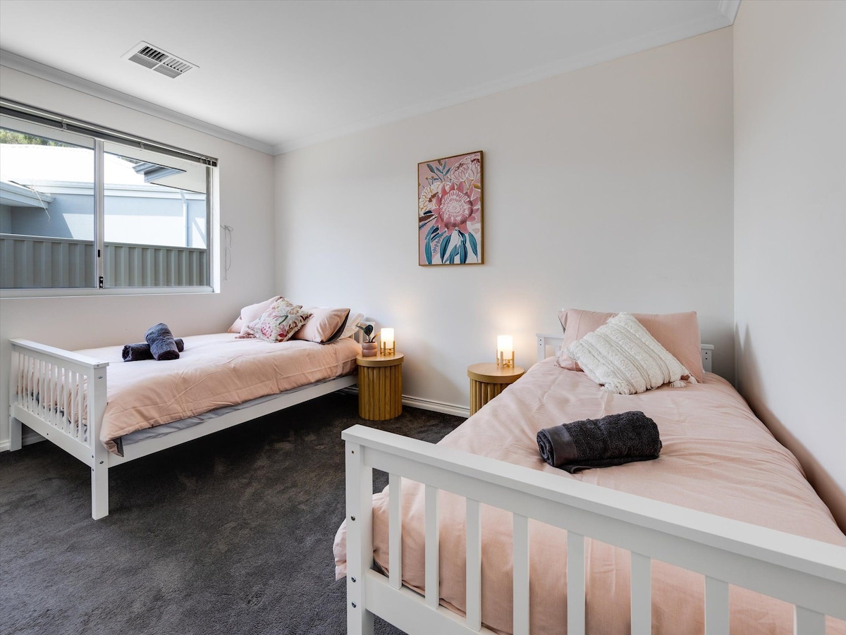 large bedroom featuring double and single bed. spacious build-in robe with loads of hanging space. 