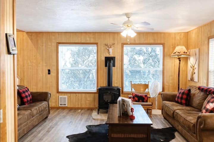 Cozy living room with comfortable seating and an indoor fireplace—perfect for relaxing evenings in a warm cabin setting.
