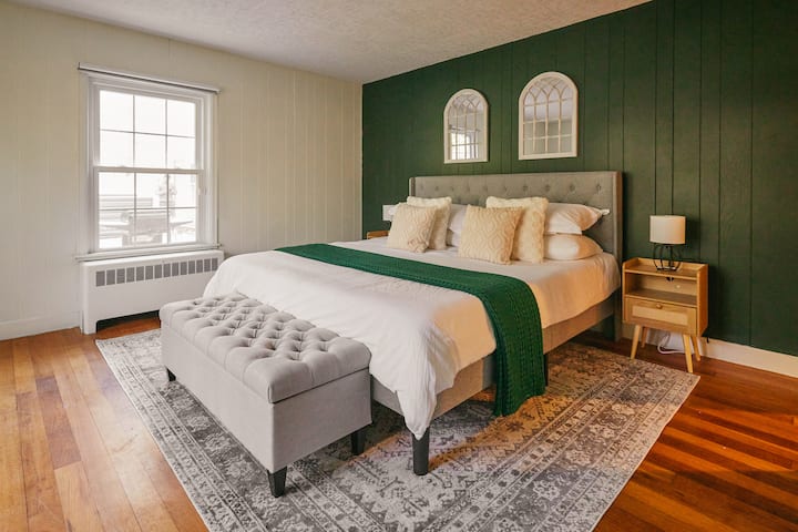 Forest Bedroom with comfy Nectar bed, organic cotton sheets, arthopedic pillows + feather pillows, blackout blinds, working desk, sink, and a TV