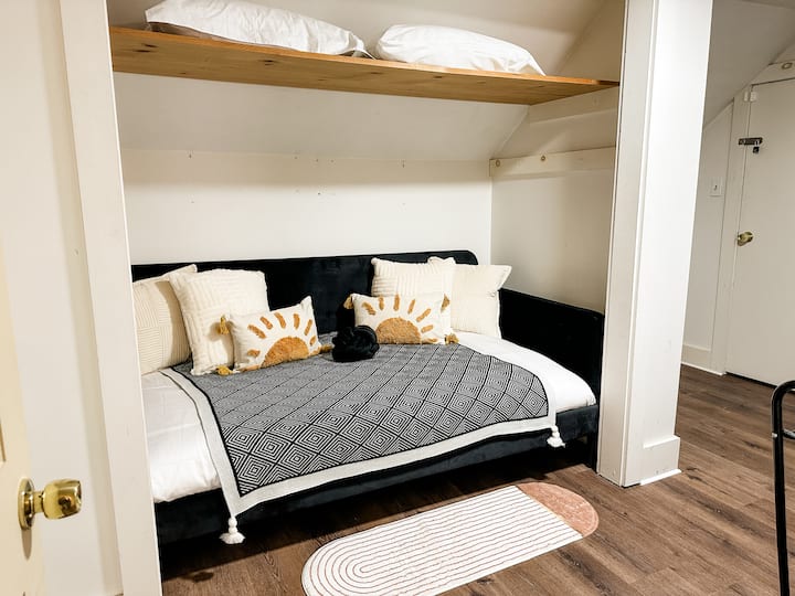 Twin bed/sofa couch small room that doubles as a game room