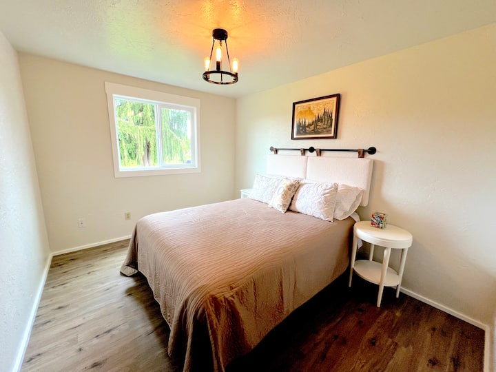 The 3rd bedroom has a queen bed, with linen sheets, and a quilted  blanket.  The window faces west with views of the countryside fields.  The window has blackout blinds to provide a peaceful nights sleep.