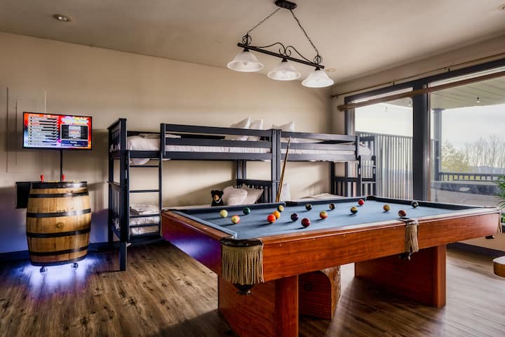 [Game Room, Lower Level] Endless entertainment for the family! Arcade and pool table.

4 Twin bunk beds with comfortable memory foam mattresses. Right behind you is a wet bar, minifridge, and shuffleboard game.