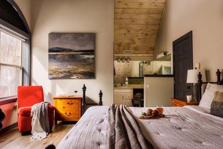 [Bedroom #2, Upper Level] Features a king-sized bed, en-suite bathroom, a smart TV, lamps with USB charger, a dresser, and a closet 