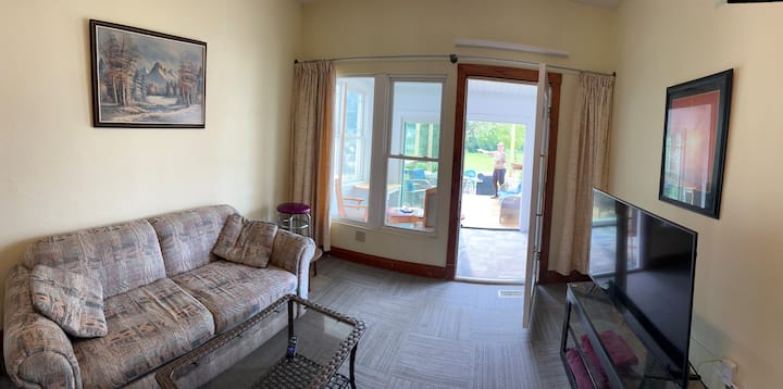 Full Size Sleeper Sofa. Sheets under the coffee table.  Doors open up to sunroom and patio doors to the deck.