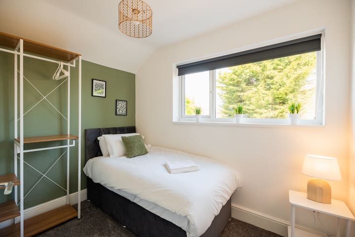 Unwind in the comfortable bed after a busy day, with bedside lighting and a mirror making it easy to settle in. Guests can relax, get ready for the day and enjoy a restful night with the wardrobe providing convenient storage during their stay.