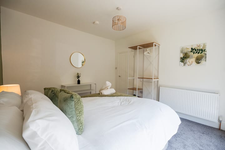 Unwind in the comfortable bed after a busy day, with bedside lighting and a mirror making it easy to settle in. Guests can relax, get ready for the day and enjoy a restful night with the wardrobe providing convenient storage during their stay.