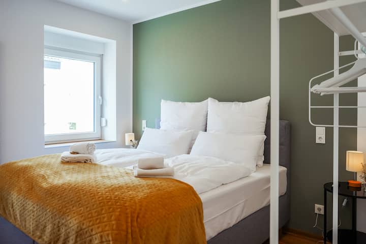Relax in the box spring bed with comfortable bedding. Equipped with a smart TV and desk, the bedroom offers comfort and functionality.
