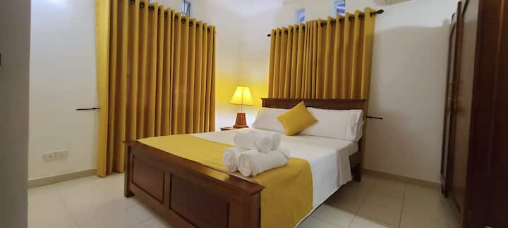 This is the First bedroom in the house, it has a ceiling fan, air conditioner, and a wardrobe.