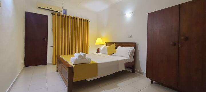 This is the third bedroom in the house, it has an air conditioner, ceiling fan, and an attached bathroom with a private courtyard.