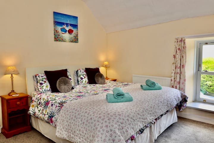 The super king bedroom overlooks the front garden. The bed can be split into two full size single beds if requested at the time of booking. 