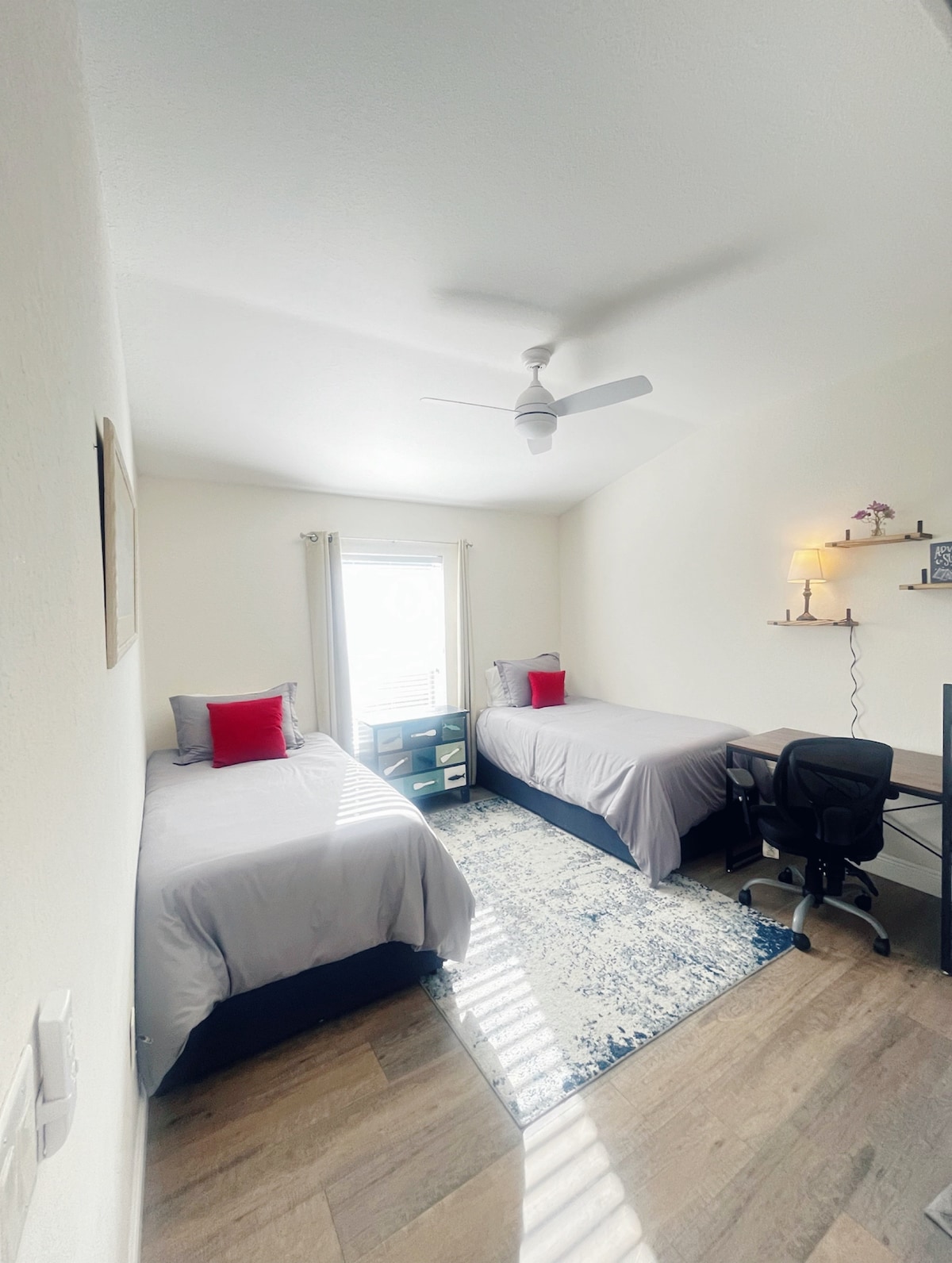 Main floor bedroom next to full bathroom. Two twin-sized memory foam mattress, closet, room darkening shades, desk.