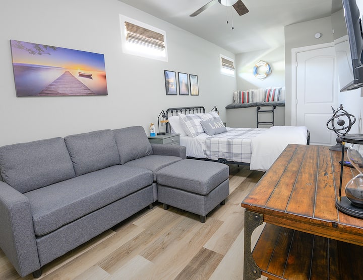 The upstairs garage apartment bedroom features a small couch with ottoman, ROKU TV, a full\double bed and fun reading nook (nook safety rail added after this pic was taken)
