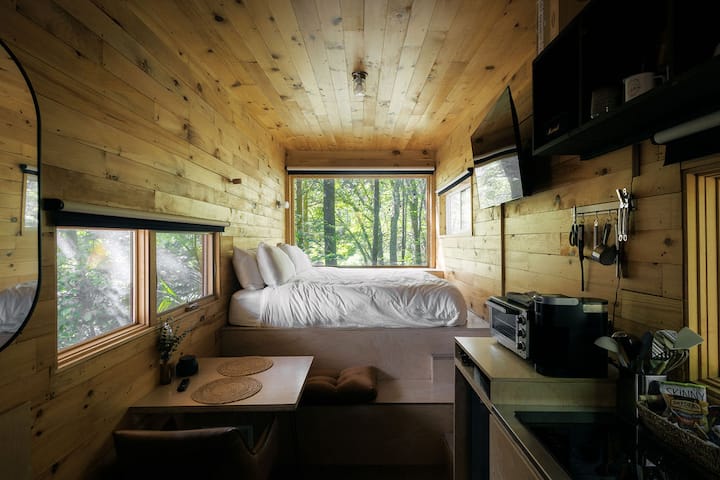 Plentiful windows allow natural light and plenty of opportunity to see wildlife from the cozy bed.