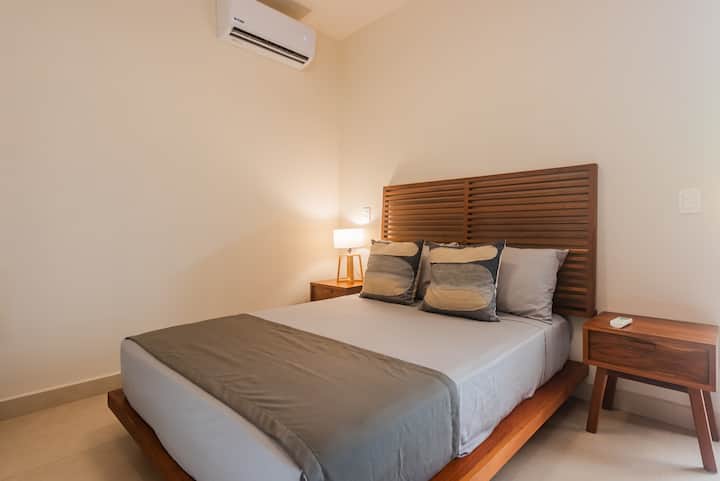 Chumba cha kulala cha chini chenye hewa safi kabisa chenye kitanda cha watu wawili.