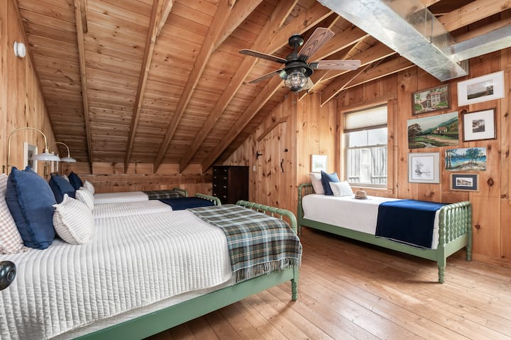 The bunk room with four twin size beds and cozy pillows