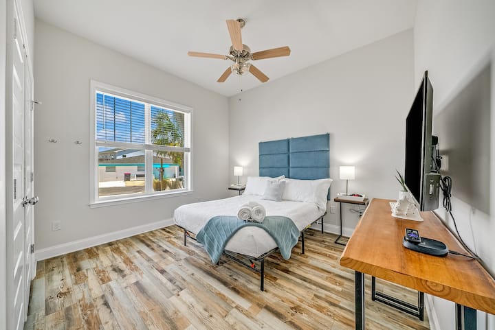 [Bedroom, Downstairs] 
Cozy and serene retreat awaits in this first floor bedroom near the downstairs bathroom. Unwind in the comfort of a double bed. Stay connected with USB plugin lamps and enjoy entertainment on the Smart TV with Roku. 