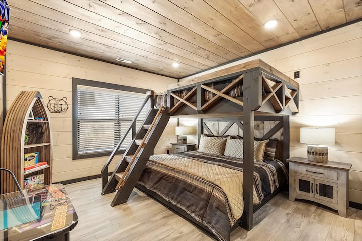 Next to the entertainment area, features a large bunk bed with a king on the bottom and a queen on top, a large TV, a gaming table, a private bathroom, and a closet. The view from this room captures the beauty of the sunset every evening.