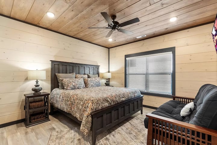 On the upper floor, with a king bed, a futon for extra seating or sleeping space, a large TV, a personal shower, a bathroom, and a closet. With the best view in the house, you can enjoy breathtaking sunrises over the Smoky Mountains every morning.