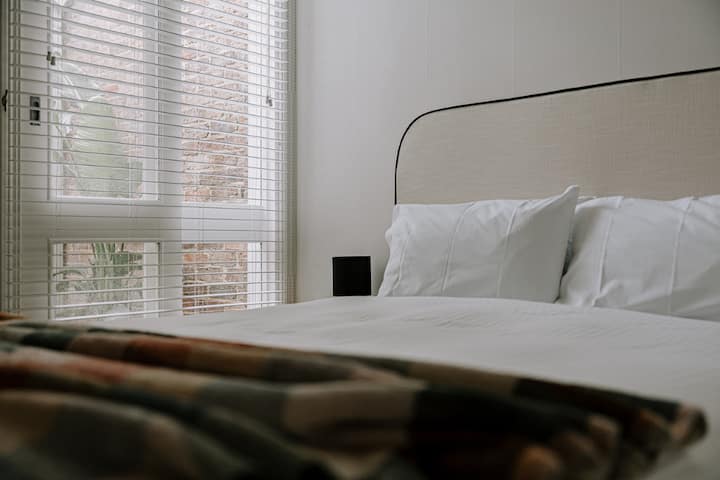 By day, the light in this bedroom & view of the greenery in the light well are gorgeous. When it's time for sleep, you are assured a relaxing night's rest in our luxurious beds with hotel-quality linens.