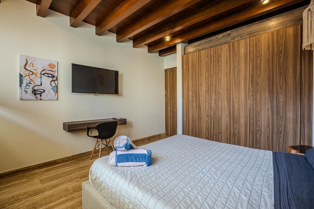 *een bureau in deze kamer * Deze speciale werkruimte is helder en kalm en bevat een houten bureau en voldoende licht - perfect voor werken op afstand of creatieve momenten