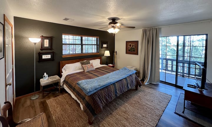 Cama tamaño king con colchón de espuma viscoelástica de Thuma en el piso inferior. La puerta del patio conduce a la terraza. 