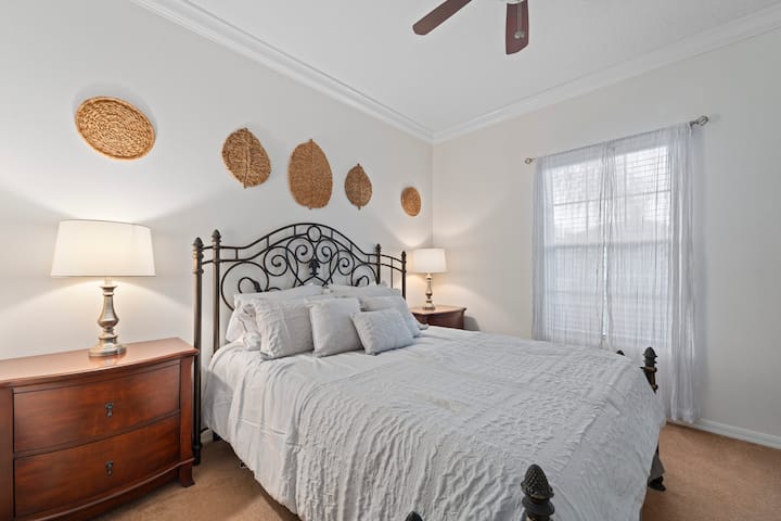 Elegant iron bed, serene decor, and soft lighting for ultimate relaxation!