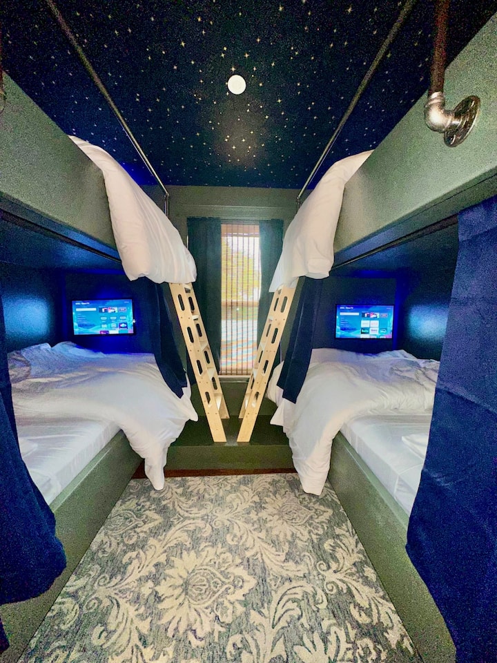 Welcome to the Hideaway Bunkie!  This fun and cozy room is sure to be a hit with both children AND adults, featuring a starry sky ceiling, 2 sets of built in XL bunks, each with a storage shelf, reading lights, fans, Roku TV and USB outlets.  
