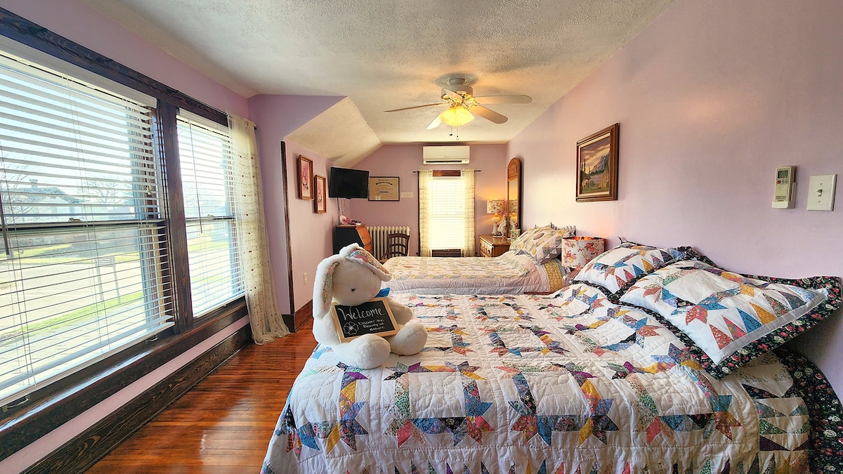 Located on the 2nd floor, this room features 2 double beds, adorned with unique quilts, thoughtfully curated decor that pays tribute to Iowa’s state flower, the Prairie Rose. This room blooms with Midwestern charm & offers a warm, welcoming retreat.