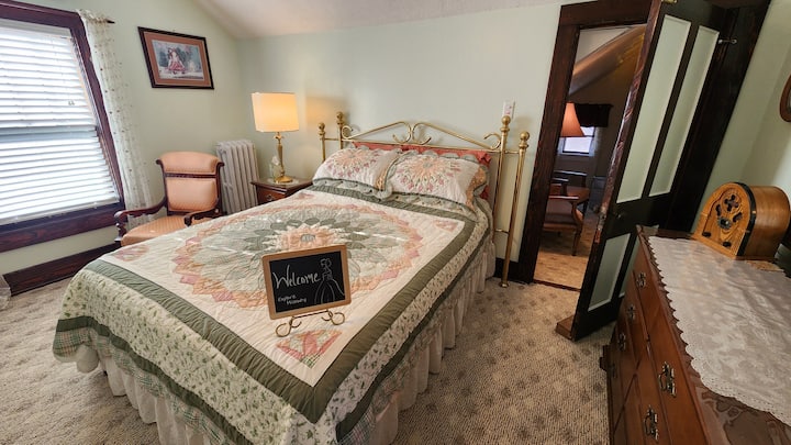 Located on the 2nd floor, this bedroom features vintage furnishings & decor inspired by the Eisenhower era, including unique quilts in Mamie's favorite colors & carefully curated pieces that offer a nostalgic peek into mid-century history.