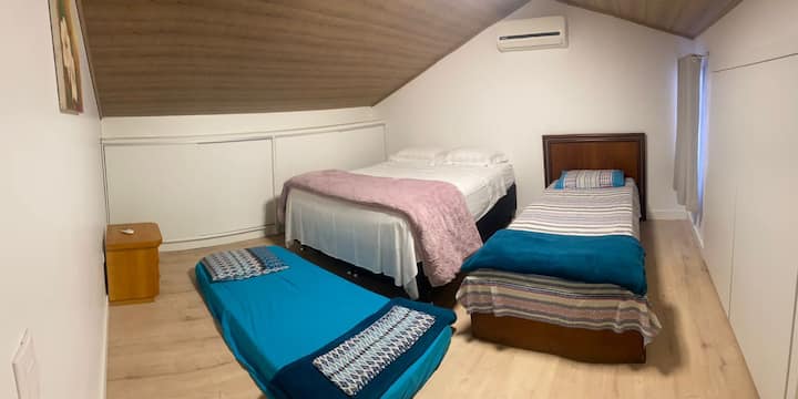 Bedroom 2nd floor with a queen bed, a single bed and a single mattress