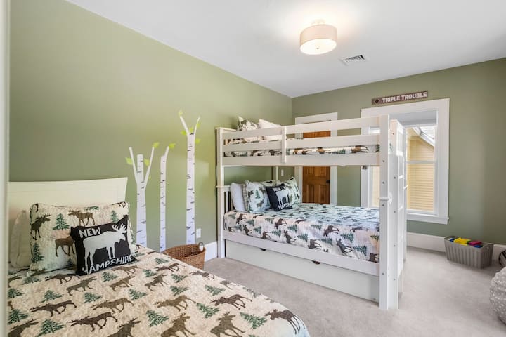 The bunk room has a full over full bunk bed, and a twin bed with twin trundle bed. 