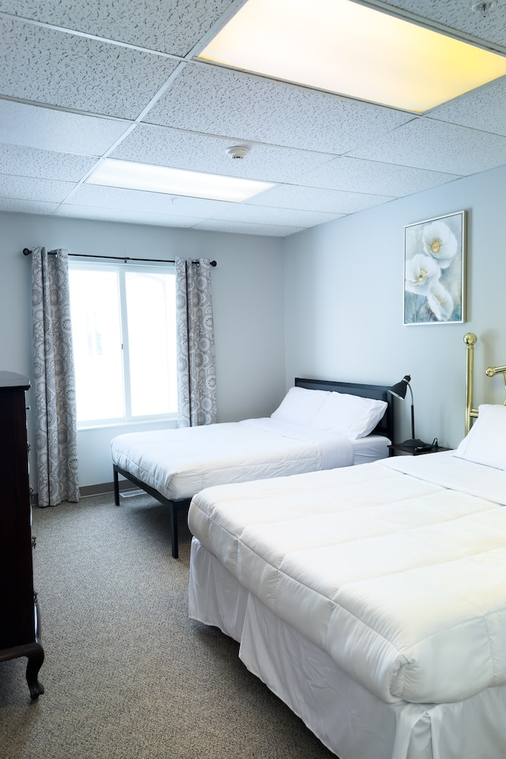 Bedroom 8 features a queen bed and a full size bed. The bedroom also has a smart tv and an attached full bathroom.