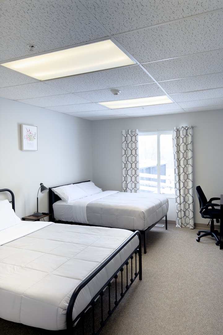 Bedroom 9 consists of a queen bed and a full bed. Bedroom 9 has an attached full bath. It is also equipped with a smart TV.