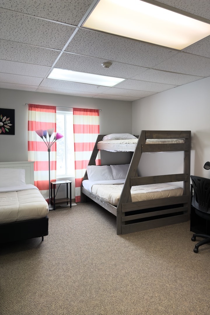 Bedroom 6 features a twin bed and a twin over full bunk. This bedroom also has an attached half bathroom. 