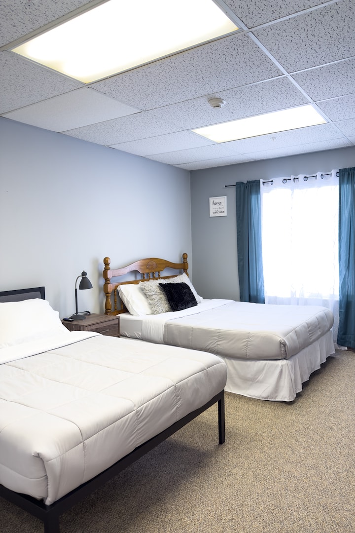 Bedroom 5 has a full and a queen bed. This bedroom has a smart tv and an attached bathroom. The bathroom also has access from the hallway.