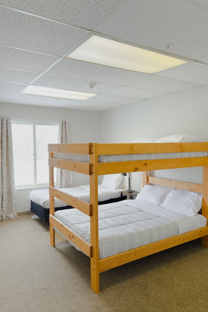 Bedroom 10 consists of a twin bed and a full over full bunk bed. Bedroom 10 has an attached half bath and has hallway access to a full bath. 