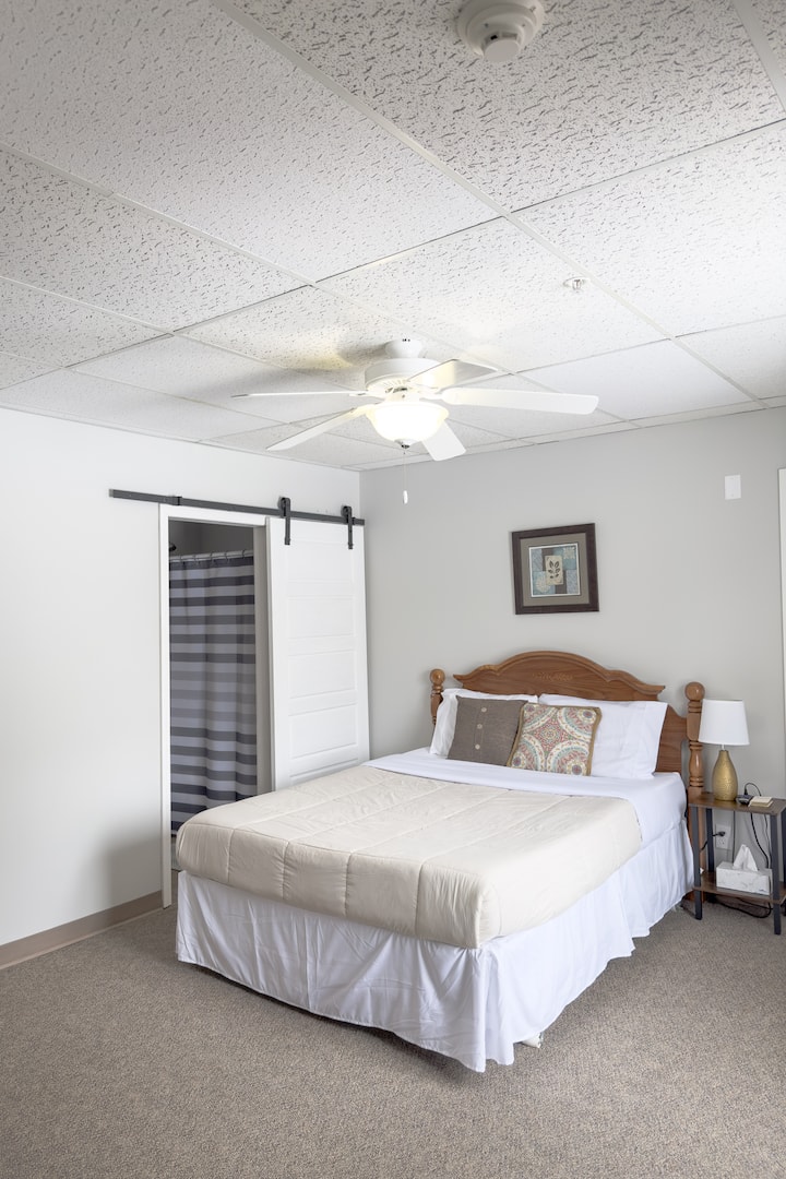 The second master bedroom has a queen bed and an en suite bathroom. This bedroom also has a smart tv. 
