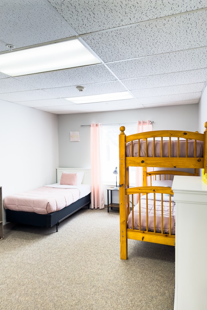 Bedroom 3 consists of a twin bed and twin over twin bunk beds. This bedroom has an attached half bathroom and access to a full bathroom in the hallway. 