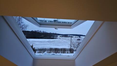 Attic floor with views over fields and sea.