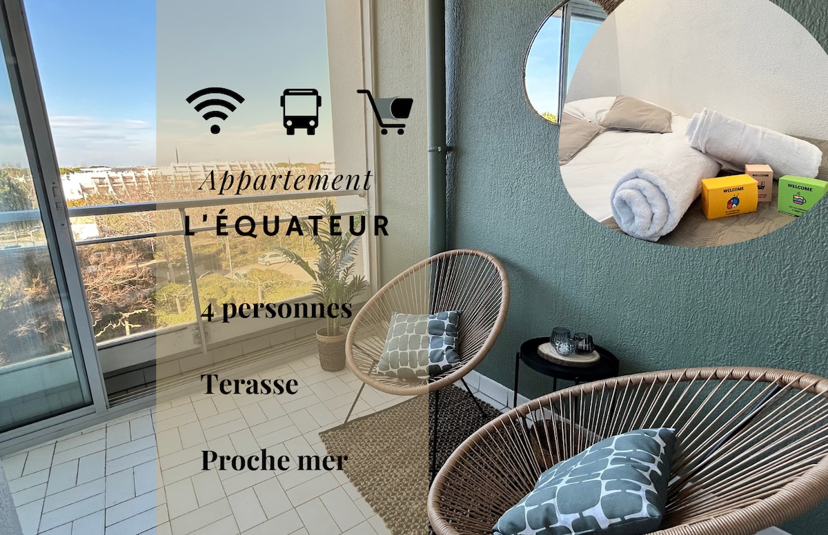 A cozy terrace is outfitted with two comfortable chairs and a small table, creating a welcoming space for relaxation. Sunlight streams through large sliding glass doors, enhancing the bright atmosphere. A pile of neatly arranged towels and welcome kits sits nearby, ready for guests to use.