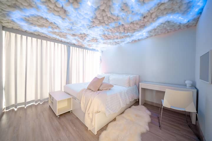 This cozy bedroom features a unique puff cloud design, creating a soft and inviting ambiance. The gentle, cloud-like aesthetic adds a relaxing and dreamy touch, making it the perfect retreat for restful sleep and relaxation.