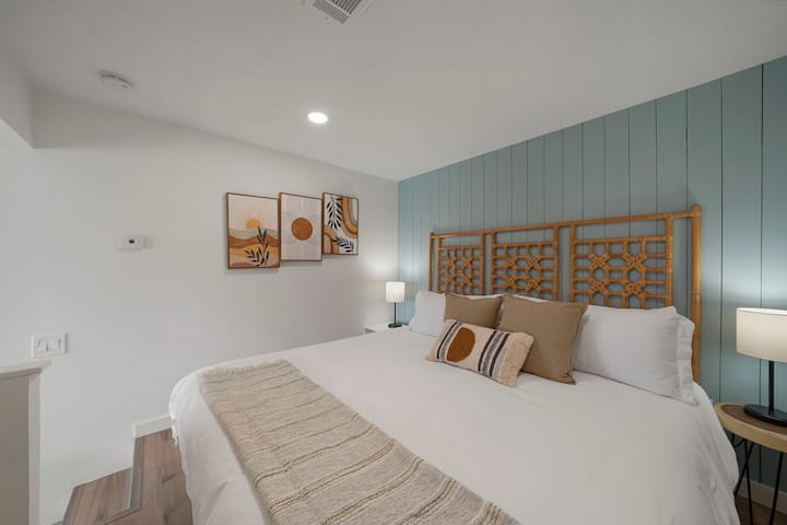 A plush king-size bed, adorned with crisp white linens and inviting pillows, beckons you for a restful night's sleep.