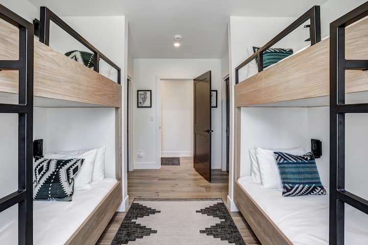 The custom built bunk room sleeps four guests, with ample room for storing luggage and clothes in two large closets. Cozy up with your own personal charging station and reading light. Perfect for kids and adults!
