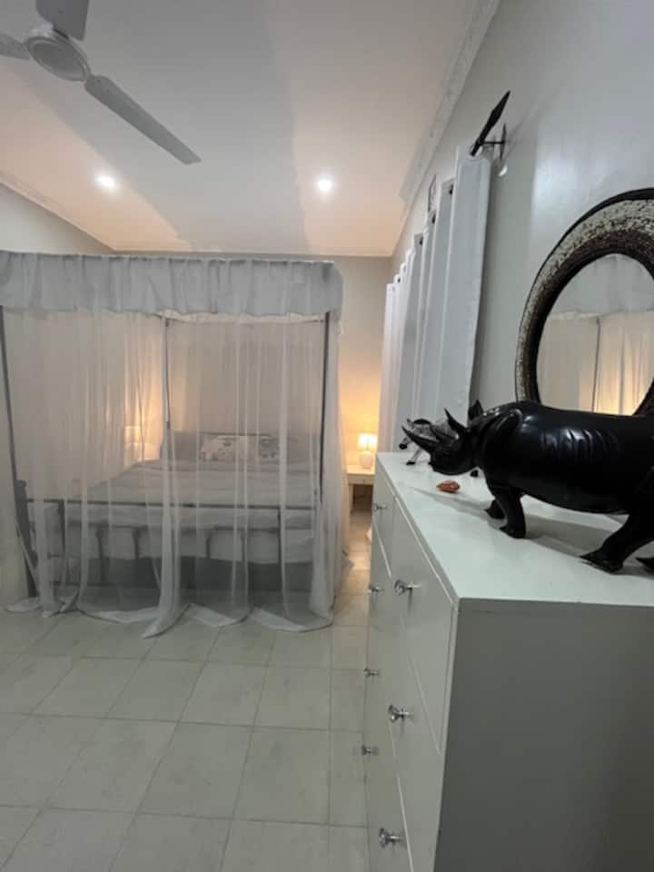 这间主卧配备一张加大双人床、蚊帐和吊扇。 它配有您自己的独立套房浴室。太可爱了！